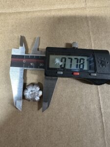 A bullet being measured.