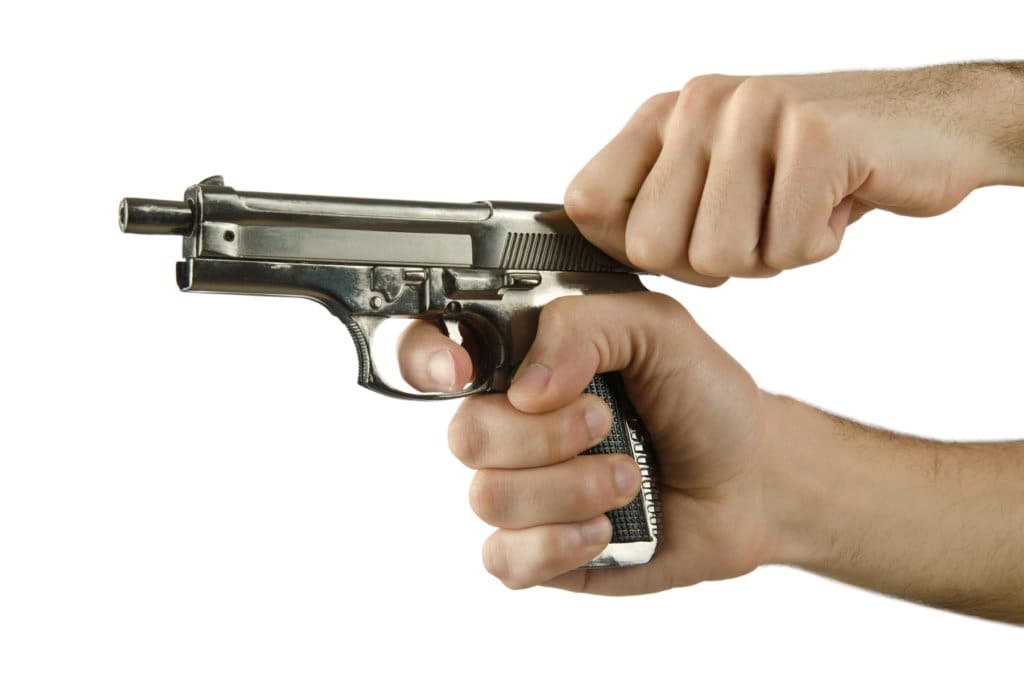 Man holding gun with finger on the trigger