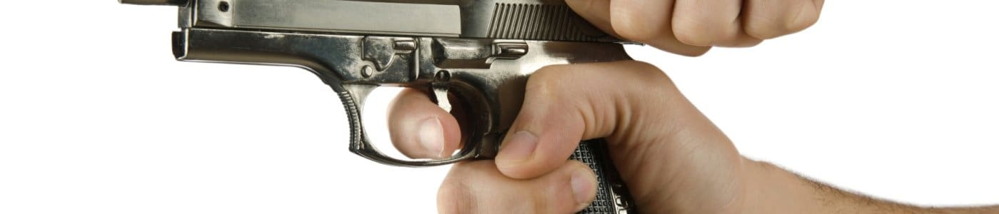 Man holding gun with finger on the trigger
