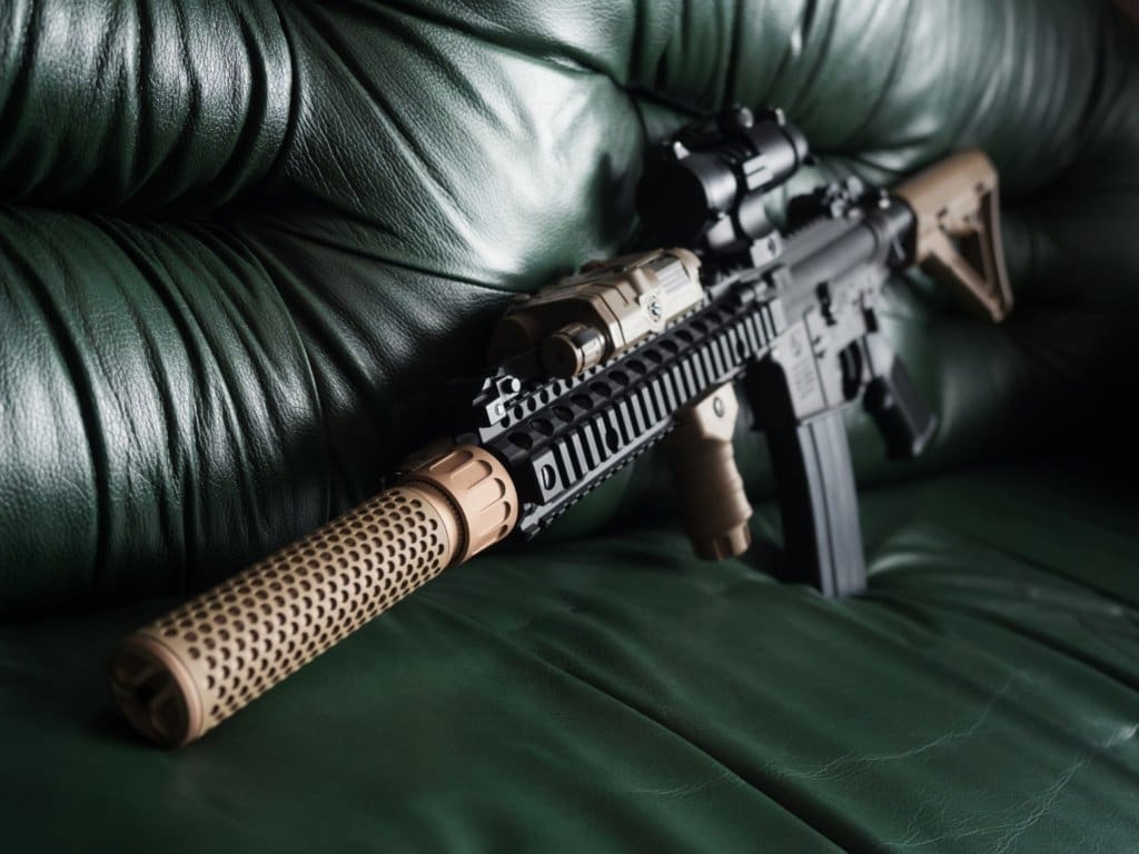 Black Rifle with suppressor On Sofa to illustrate how to buy a suppressor