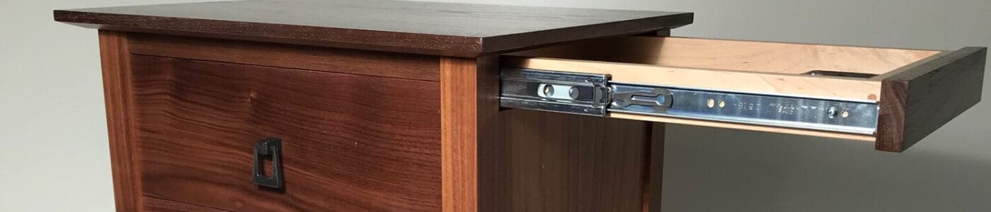 An end table that has hidden compartments for your guns to illustrate how to hide a gun safe in plain sight. Image from qlinedesign.com.