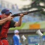 man shoots a sporting rifle in Olympics