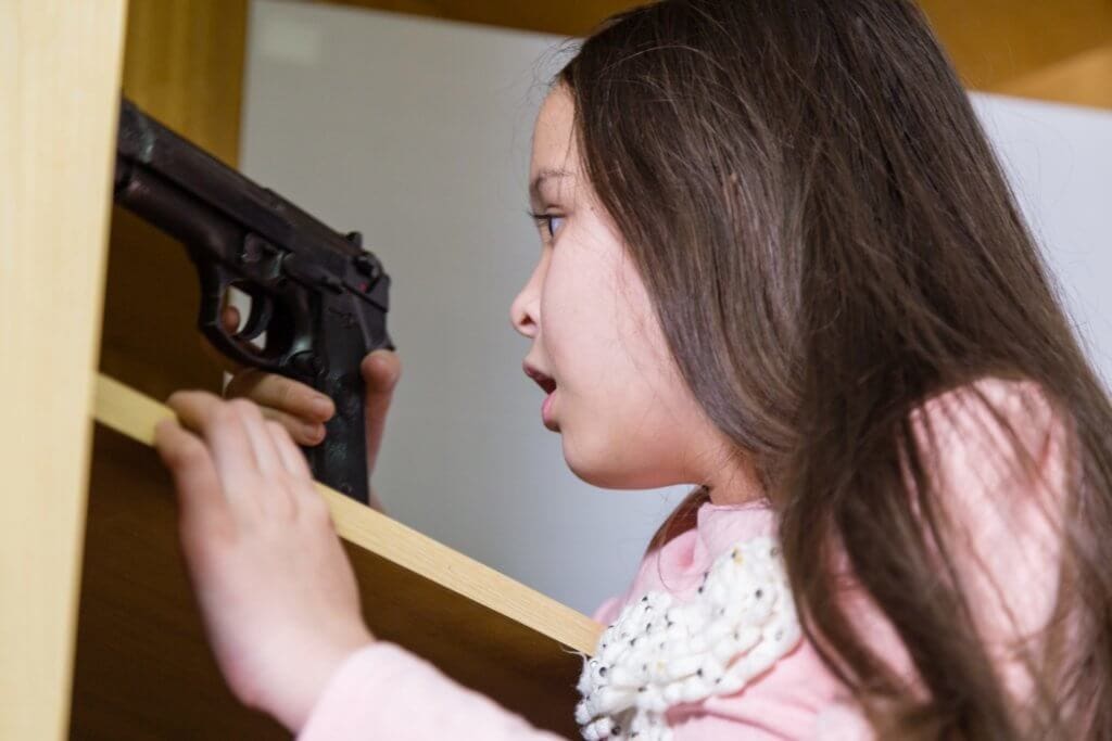 Young girl finds gun in closet to illustrate Teaching Kids About Guns and Gun Safety
